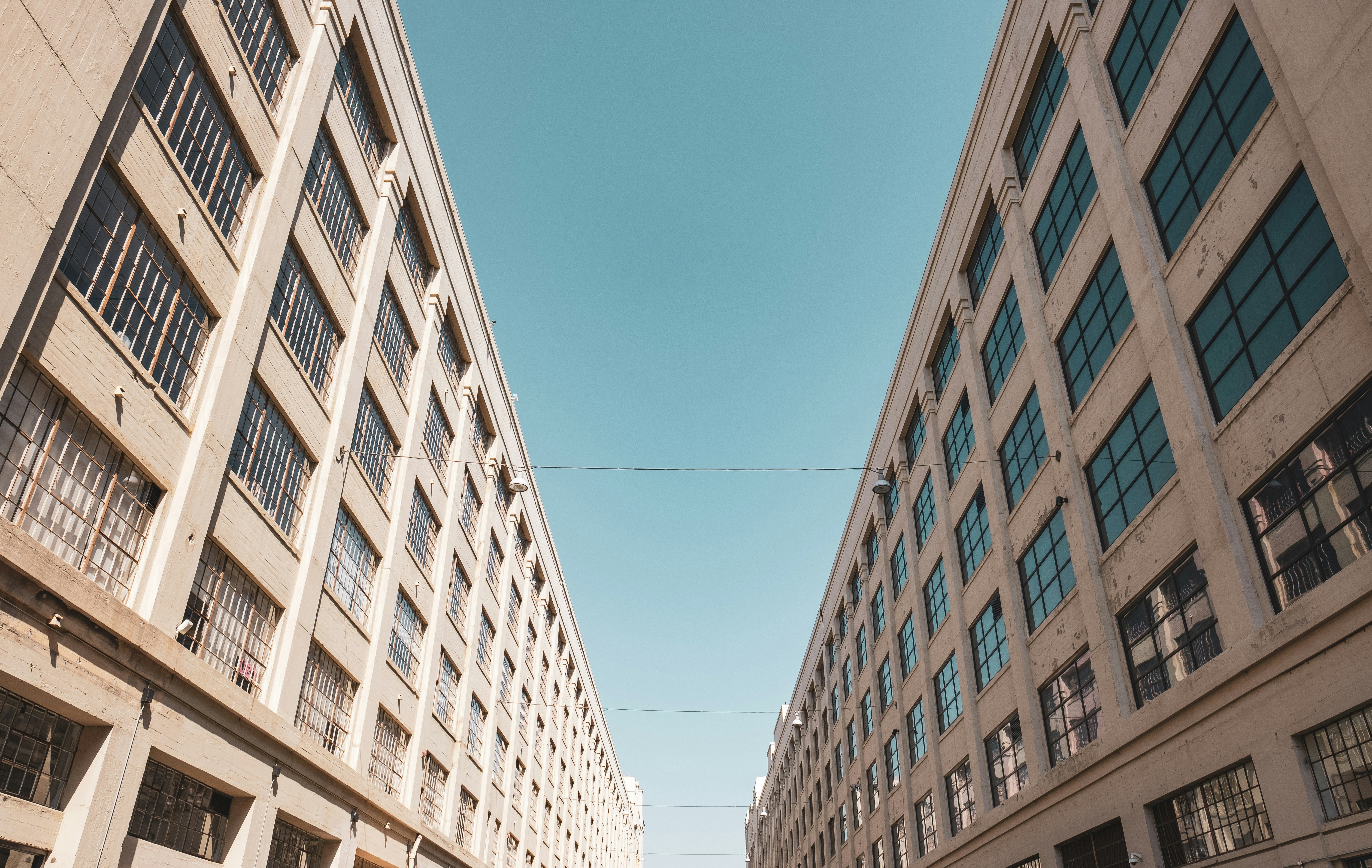 street between white buildings under blue sky